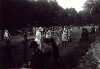 Ett antal dansande personer.
Nyckelord: Ringdans