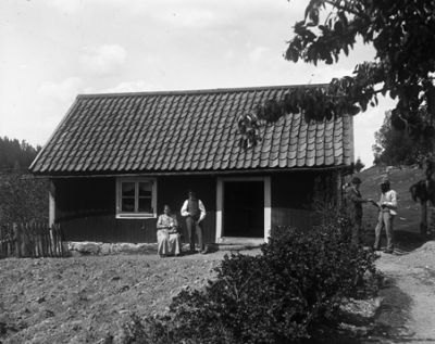 3 män och en kvinna vid hus
Nyckelord: Hus Buske