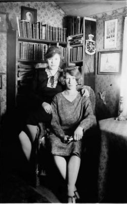 2 kvinnor sittande i fotölj.
Nyckelord: Bokhylla