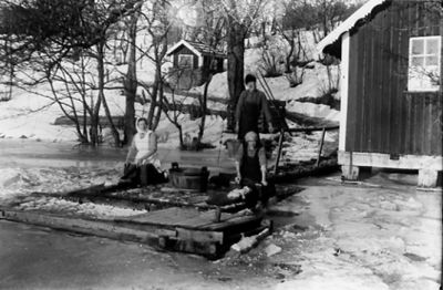 Man och 2 kvinnor på brygga sysselsatta med bykning.
Nyckelord: Vinter