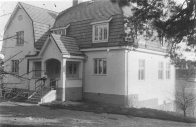 Pojke sittande på räcke till byggnad.
Nyckelord: Byggnadsstil