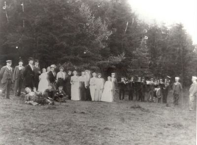 Festklädda människor och musikkår i skogsglänta
Nyckelord: Musikinstrument Dräkt