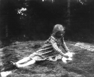 Flicka med kattunge sittande på marken
Nyckelord: Katt