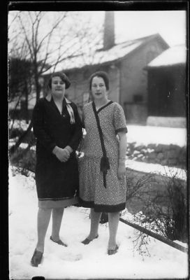 2 kvinnor stående intill vattendrag.
Nyckelord: Vinter