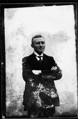 Man stående vid vägg.
