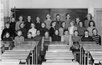 Skolklass med lärarinna i skolsal
