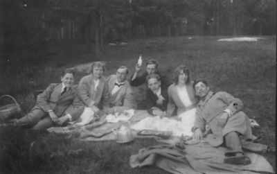 5 män och 2 kvinnor sittande på filt i gräset.
Nyckelord: Filt Picnic