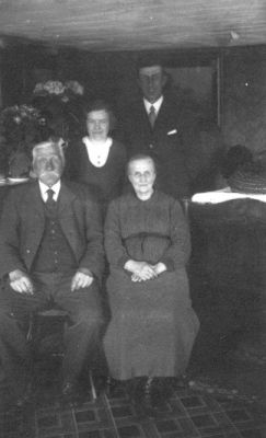 Man och kvinna sittande och man och kvinna stående i rum.
Nyckelord: Blommor