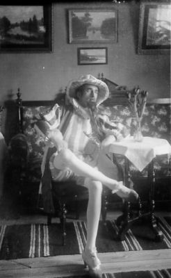 Utklädd man sittande i rum.
Nyckelord: Dräkt Tavla