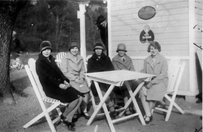 5 kvinnor sittande vid trädgårdsmöbler framför kiosk.
Nyckelord: Trädgårdsmöbel Kiosk