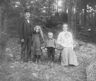 Man kvinna och 3 barn i skogsbacke
Nyckelord: Dräkt